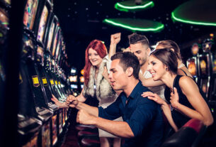 Group of people playing slot machines