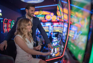 handsome couple having fun and drinking wine at casino